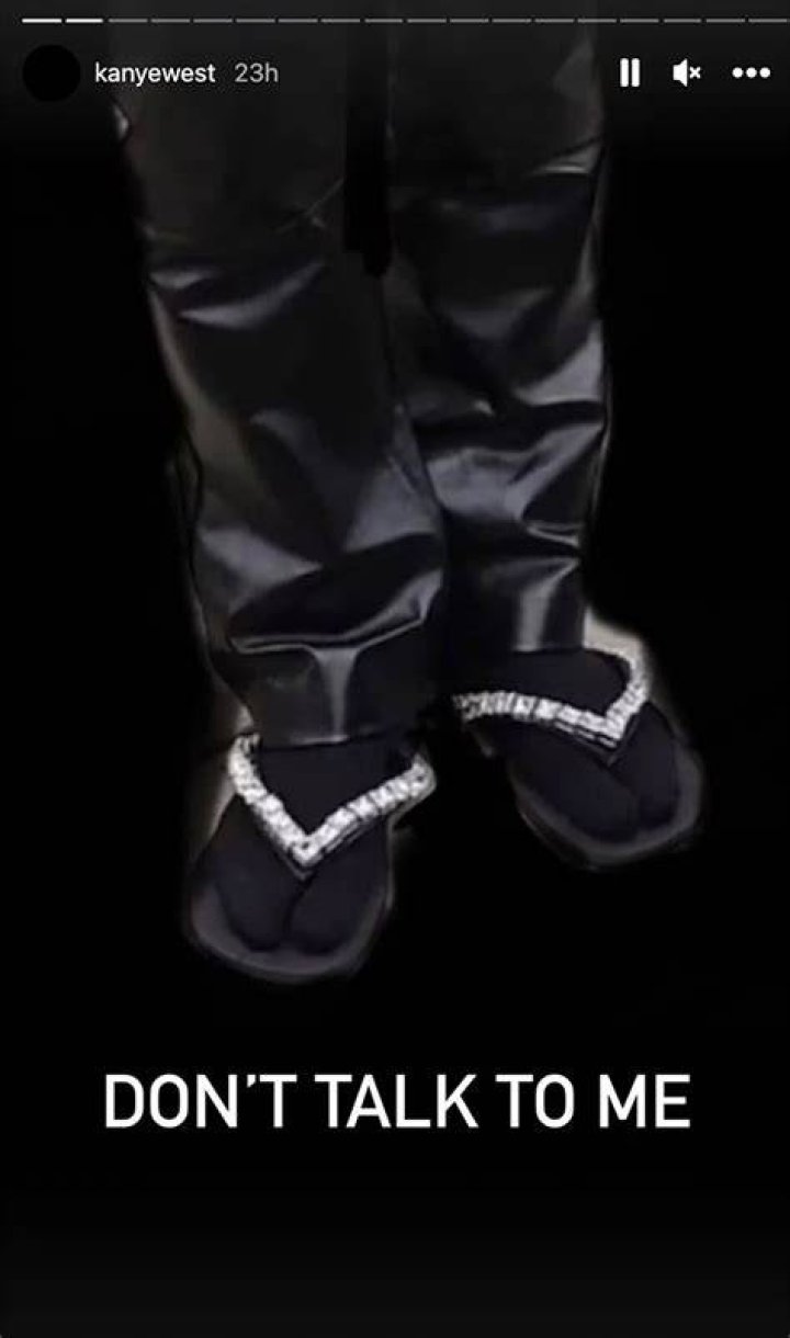 
Kanye West Steps Out at Burberry Show in Bedazzled Flip Flops and Socks: ‘Don’t Talk to Me’ 
